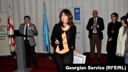 RFE/RL Tbilisi Bureau Chief Marina Vashakmadze (center) accepting the "Champion of Tolerance" award from Georgian Public Defender's Office head Beka Mindiashvili (left) during a ceremony in Tbilisi, 15Nov2012