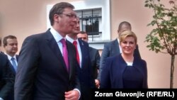 Serbian Prime Minister Aleksandar Vucic (left) and Croatian President Kolinda Grabar-Kitarovic gave the impression of performing a mildly unpleasant but unavoidable duty, doing their best to project an image of harmony and friendship. 