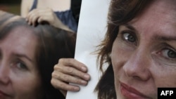 Russian activists hold portraits of slain human rights worker Natalya Estemirova.