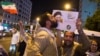 A supporter of Ebrahim Raisi kisses his poster during a presidential campaign rally in Tehran in 2017. The conservative cleric lost his bid for the presidency the last time around, but is seen as a front-runner in this year's vote. 