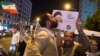 A supporter of Ebrahim Raisi kisses his poster during a presidential campaign rally in Tehran in 2017. The conservative cleric lost his bid for the presidency the last time around, but is seen as a front-runner in this year's vote. 