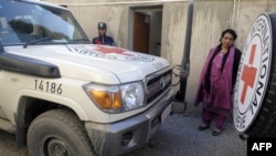 A Pakistani employee of the International Committee of the Red Cross (ICRC) stands next to the vehicle of British employee Khalil Ahmad Dale in Quetta in January, when Dale was abducted.