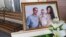 A photo of Igor, Milana, and Anastasia Kramarenko, who died in the collapse, is displayed before a farewell ceremony in Magnitogorsk on January 4.