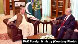 Pakistani Foreign Minister Shah Mahmood Qureshi (left)meets with U.S. envoy Zalmay Khalilzad in Islamabad on December 13.