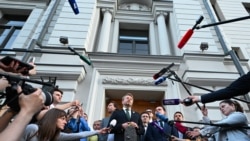 Yabloko party leader Nikolai Rybakov speaks to the media outside the Russian Supreme Court in Moscow on August 10, 2026.