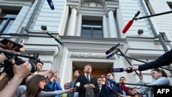 Yabloko party leader Nikolai Rybakov speaks to the media outside the Russian Supreme Court in Moscow on August 10, 2026.