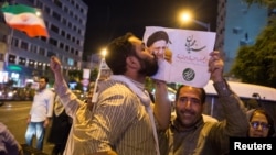 A supporter of Ebrahim Raisi kisses his poster during a presidential campaign rally in Tehran in 2017. The conservative cleric lost his bid for the presidency the last time around, but is seen as a front-runner in this year's vote. 