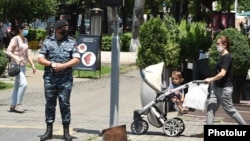 Armenia -- A masked police officer patrols streets of Yerevan, July 10, 2020.