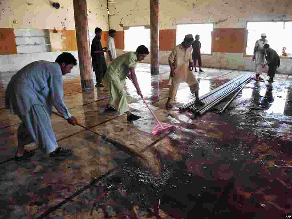 Local residents clean a mosque after a suicide bomb attack in the town of Jamrud, 25 kilometers from Peshawar. A suicide bomber hit a Pakistani mosque during Friday Prayers, killing at least 43 people and wounding more than 100 others.Photo by A. Majeed for AFP