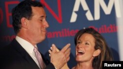 Republican presidential hopeful Senator Rick Santorum celebrates with his wife Karen after winning primaries in Alabama and Mississippi.