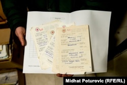 The curator of the museum in Potocari, Azir Osmanovic, holds a letter donated to the museum by Ahmed Hrustanovic.