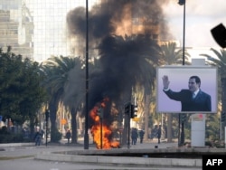 Tunisia -- Smoke rises from fire left after clashes between security forces and demonstrators in Tunis, 14Jan2011