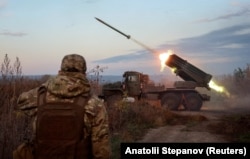 Ukrainian soldiers fire a BM-21 Grad multiple rocket launch system near the frontline town of Kostyantynivka.