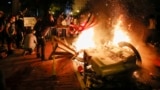 U.S. -- America Protests Washington -- Demonstrators start a fire as they protest the death of George Floyd, Sunday, May 31, 2020, near the White House in Washington. Floyd died after being restrained by Minneapolis police officers