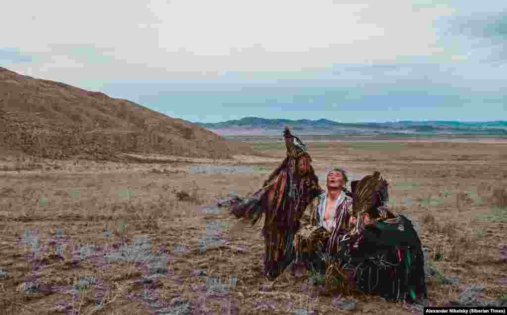 An exhausted shaman after a ceremony. Shamans say that when entering a trance they have only precarious control of their journey into the spirit world. Entranced shaman have been filmed chewing red-hot coals. 