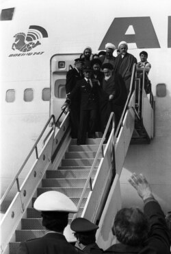 A photo taken on February 01, 1979 at Tehran airport shows Ayatollah Ruhollah Khomeini (up front R) leaving the Air France Boeing 747 jumbo that flew him back from exile in France to Tehran.