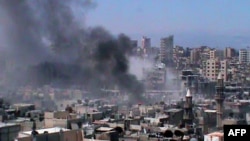 Syria -- Smoke rises from the Jouret al-Shayyah neighbourhood of the central city of Homs, 15Jul2012