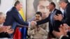 The head of the Russian state oil firm Rosneft, Igor Sechin, (left) shakes hands with the Venezuelan oil minister and the president of the South American country's state oil company PDVSA, Manuel Quevedo, in front of Venezuelan President Nicolas Maduro in Maiquetia in December 2017. 