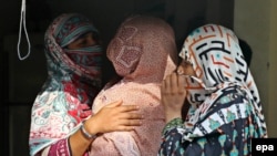 Mothers whose children were sexually abused by a gang gather at a house in the village of Hussain Khanwala in the Kasur district of Punjab province.