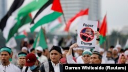 A protester in Jakarta holds up a sign during a rally to condemn U.S. President Donald Trump's decision to recognize Jerusalem as Israel's capital on December 17.