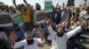 Supporters of a Pakistani religious group chant slogans while blocking a highway in the southern Pakistani city of Karachi on October 31.