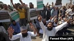 Supporters of a Pakistani religious group chant slogans while blocking a highway in the southern Pakistani city of Karachi on October 31.