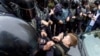 Russian police officers push a teenager during a protest rally in St. Petersburg. (file photo)
