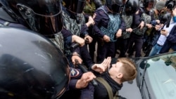 Russian police officers push a teenager during a protest rally in St. Petersburg. (file photo)