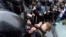 Russian police officers push a teenager during a protest rally in St. Petersburg. (file photo)