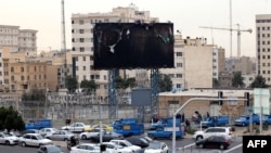 Teheran, 19 ianuarie 2026 – mașinile trec pe lângă un panou publicitar ars, în timp ce viața de zi cu zi revine pe străzi după protestel la nivel național.