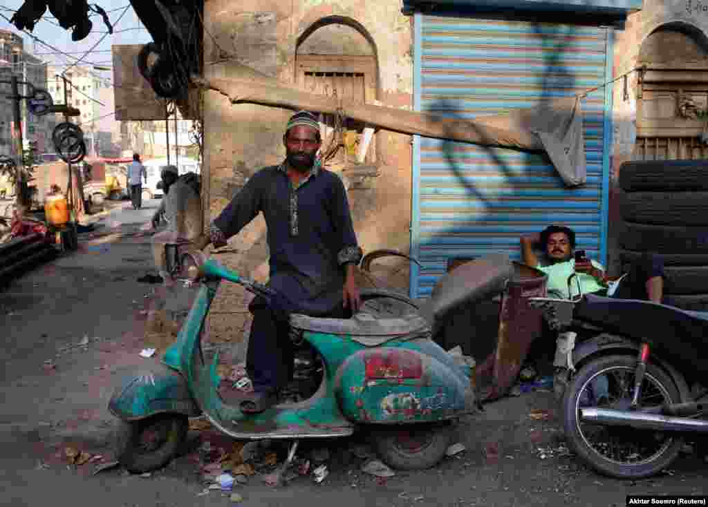 A man poses with an old Vespa. A member of Lahore&#39;s Vespa fan club told Reuters &quot;Vespas were the second-best gift Italy gave to the world -- first being pizza.&quot;