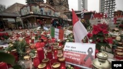 Candles, flowers, and condolence notes are placed on Breitscheidplatz square in remembrance of the victims of the December 19 terrorist attack in Berlin.