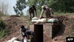 Indian villagers fortify defenses along the line of control between India and Pakistan in the restive Kashmir region