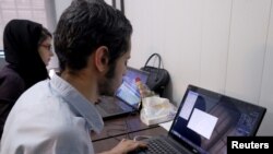 FILE PHOTO: Employees work with their laptops at Takhfifan company in Tehran, Iran January 19, 2016. REUTERS/Raheb Homavandi/TIMA/