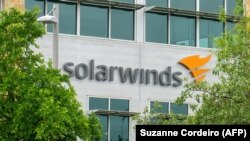 The SolarWinds Corp. logo is seen on a sign at the company's headquarters in Texas (file photo)