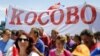 People hold a banner reading "Kosovo" during a protest against the agreement about the normalization of relations between Serbia and Kosovo in Belgrade on May 10.