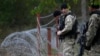 Members of Georgia's Special Forces Police secure an area near wire barricades erected by Russia in the village of Dvani.