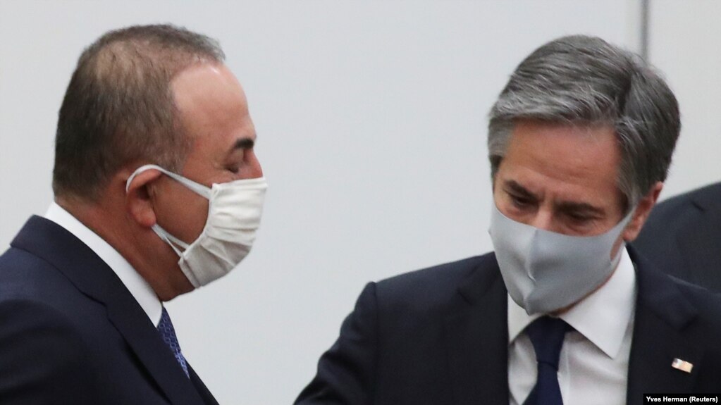 Turkish Foreign Minister Mevlut Cavusoglu (left) and U.S. Secretary of State Antony Blinken arrive at NATO headquarters in Brussels on March 23.