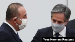 Turkish Foreign Minister Mevlut Cavusoglu (left) and U.S. Secretary of State Antony Blinken arrive at NATO headquarters in Brussels on March 23.