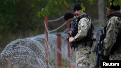 Members of Georgia's Special Forces Police secure an area near wire barricades erected by Russia in the village of Dvani.