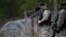 Members of Georgia's Special Forces Police secure an area near wire barricades erected by Russia in the village of Dvani.