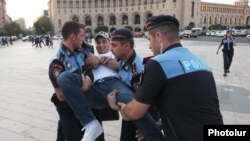 Armenian police officers carry Rise Armenia activist David Sanasarian from the scene of protest, Yerevan, 29July2015