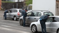 Armenia -- Police officers enforcing a coronavirus lockdown check cars leaving Yerevan, April 1, 2020.