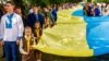 Під час відзначення Дня Державного Прапора України в Ужгороді. Учасники святкування несуть 100-метровий синьо-жовтий стяг, 23 серпня 2017 року 