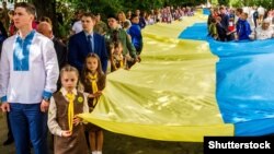 Під час відзначення Дня Державного Прапора України в Ужгороді. Учасники святкування несуть 100-метровий синьо-жовтий стяг, 23 серпня 2017 року 