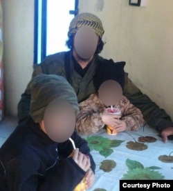 Asan in Syria with his older brother and father, both of whom reportedly died in air strikes