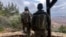 Israeli soldiers look toward Lebanon by the Israel-Lebanon border on March 7 as cross-border strikes continued.