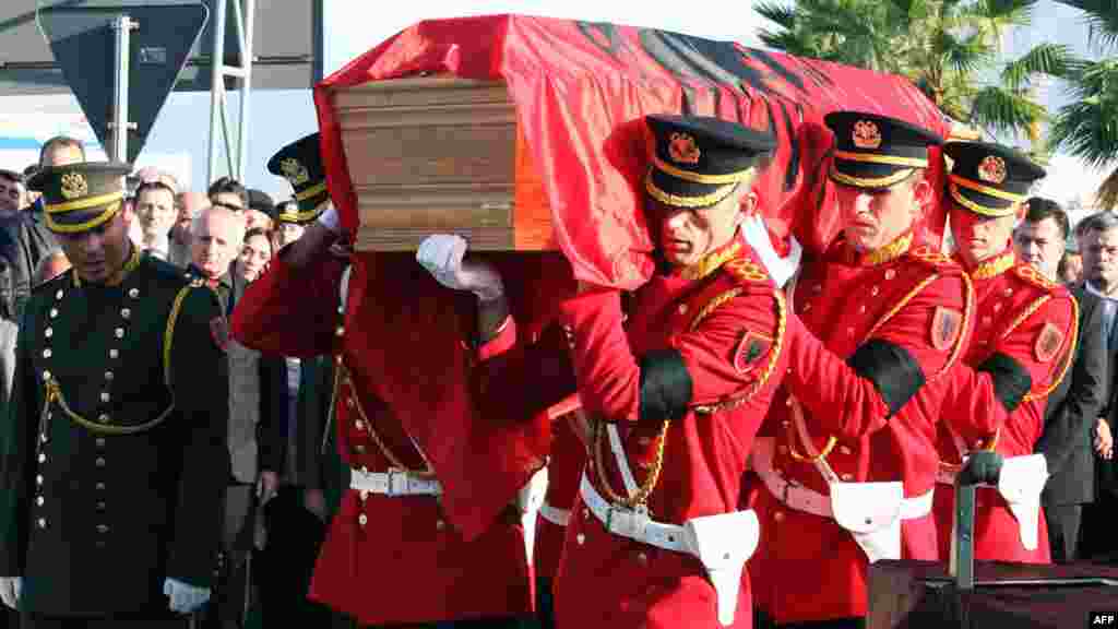 Albanian honor guards carry a coffin with the remains of Albania's self-proclaimed king, Zog I, after arriving back in his home country from France, where he died in exile in 1961. Zog's remains are due to be buried in a newly built mausoleum for the royal family in an official ceremony on November 17. (AFP)