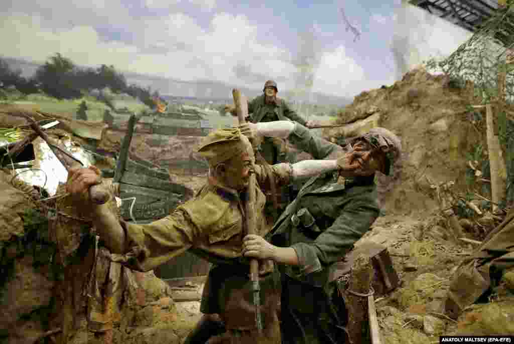 Soviet and Nazi soldiers locked in a fight to the death in a trench.