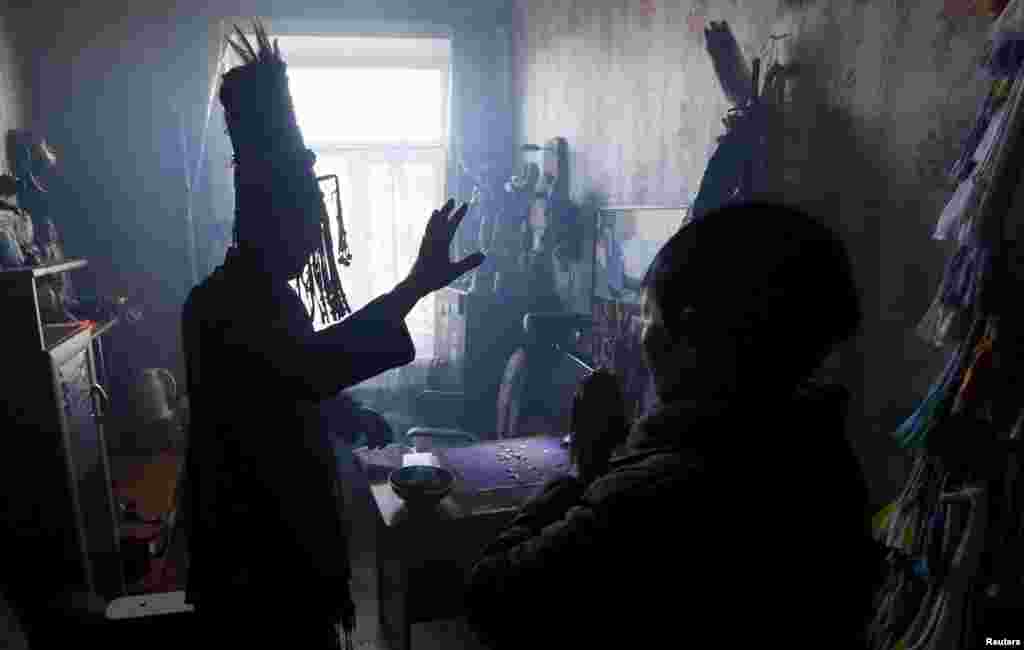 A shaman attempting to foresee the future of a customer. After exhibiting unusual abilities in his or her youth, a shaman-to-be must endure a serious illness before becoming a full shaman. Known as the "initiatory illness," its importance is due to the near-death experience carrying the shaman-to-be briefly through the spirit world. 
